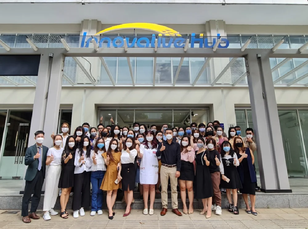 Innovative Hub Vietnam team group photo in front of the new office building, 2019